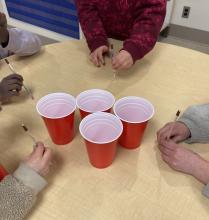 jumping stick game: get it in a cup