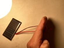 incandescent bulb on the solar panel dimly lights a 3V LED bulb